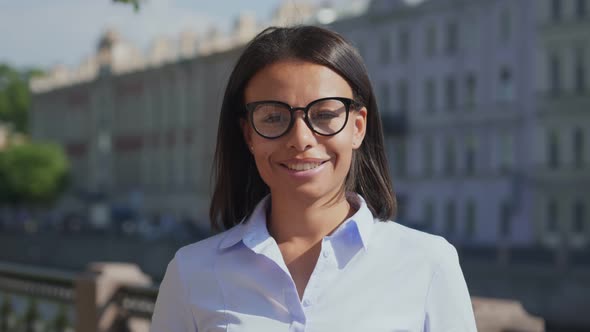 Bokeh Medium Shot of African American Businesswoman Smiling Happy and Confident Outdoors at City