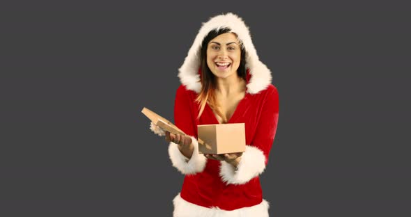 Sexy girl in santa costume opening a gift 4k