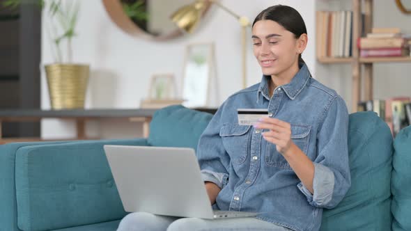 Online Shopping Success on Laptop By Latin Woman 