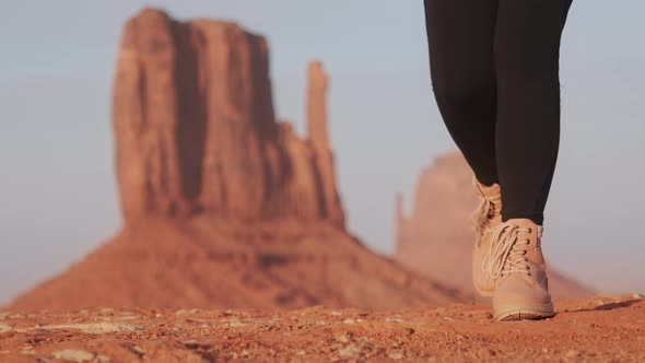 Cinematic Closeup Woman Boots Hiking in Golden Sunset Light at Monument Valley