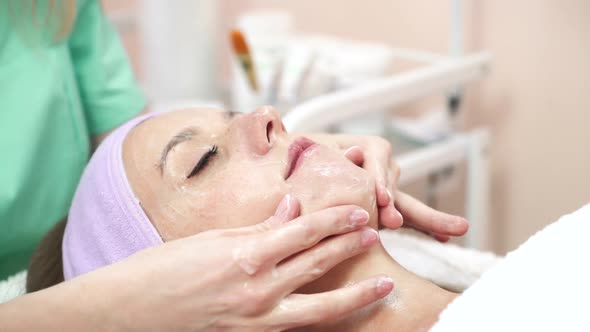 Woman relaxing in spa salon. Beautiful woman lying on the bed relaxing in spa salon with massage