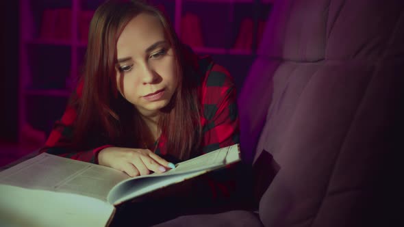 A Beautiful Student Reading a Big Book