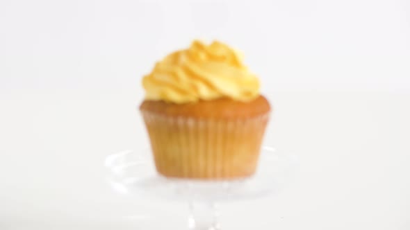 Cupcake with Yellow Frosting on Glass Stand