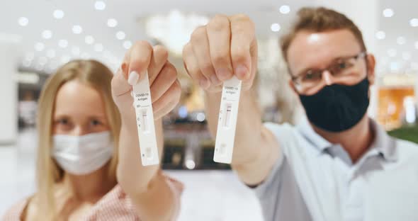 Couple Man and Woman Show Their Negative COVID19 Antigen Test to the Camera