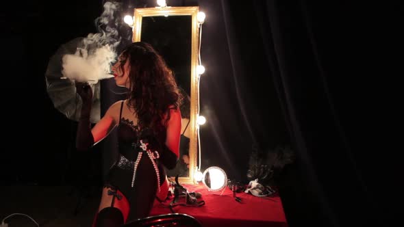 Burlesque Style Girl Smokes a Cigar