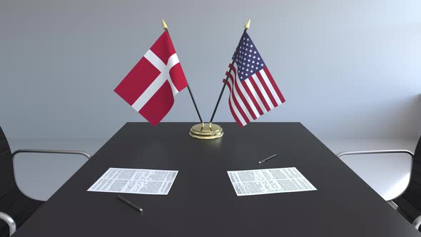 Flags of Denmark and the United States on the Table