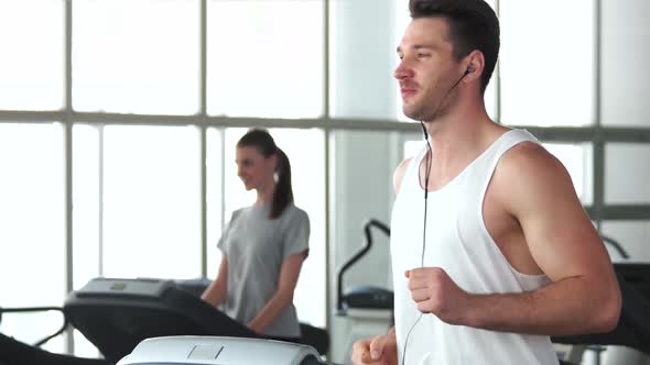 Young Athletic Man Running on Treadmill.