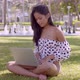 Smart Asian Woman Typing on Laptop Sitting in Grass in Park - VideoHive Item for Sale