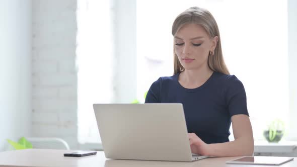 Woman Working on Laptop in Office