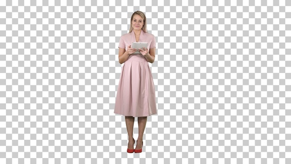 Pretty charming confident trendy woman in pink having tablet