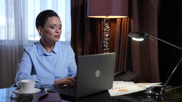 Serious Businesswoman Working on Laptop in Office