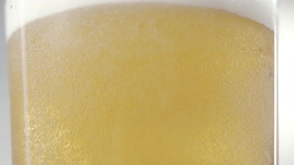 Foaming Beer is Poured Into the Glass in Slow Motion