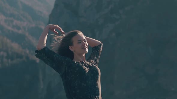 Happy Woman in Dress Raises Hands on Windy Day Slow Motion