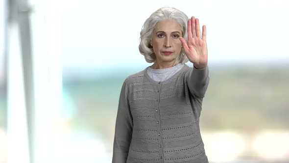 Senior Woman Making Gesture STOP with Hand.