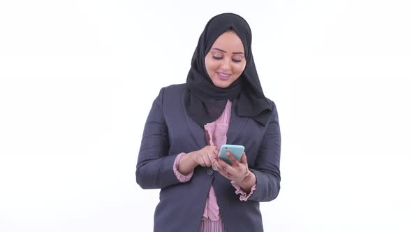 Happy Young African Muslim Businesswoman Thinking While Using Phone