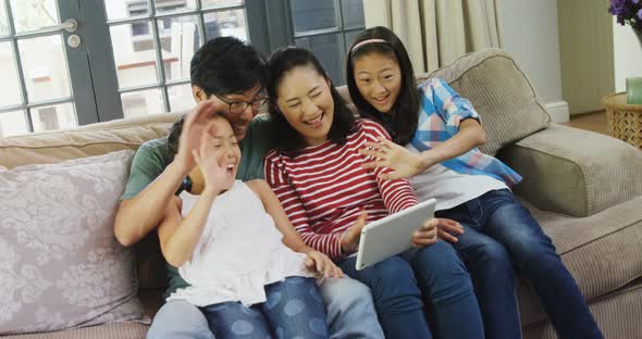 Family having a video call on laptop in living room 4k