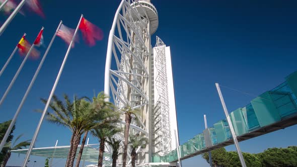 Hotel Tower with Palms and Flags in the Park of the Nations Timelapse Hyperlapse