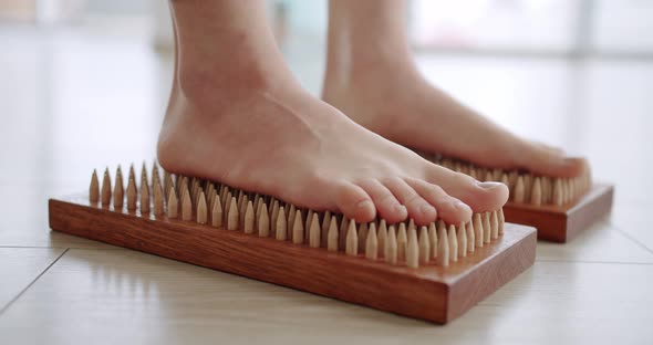 Women Feet on a Sadhu Board Doing Relaxation Exercisecloseup