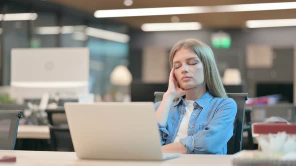 Upset Young Woman Worried While Sitting in Office