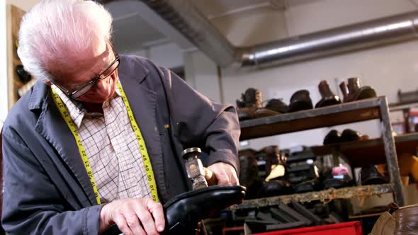 Shoemaker hammering on a shoe