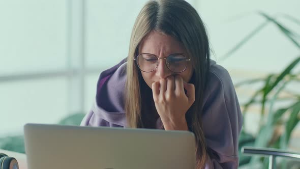 Anxious Sad Woman Looking at Laptop Feeling Frustrated of Bad News