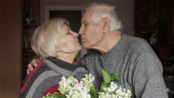 Portrait of a Happy Grandfather and Grandmother. Grandpa Kissing Gandma