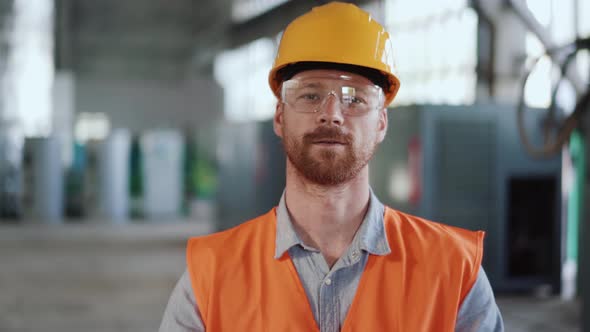 Positive man engineer in uniform looking at the camera