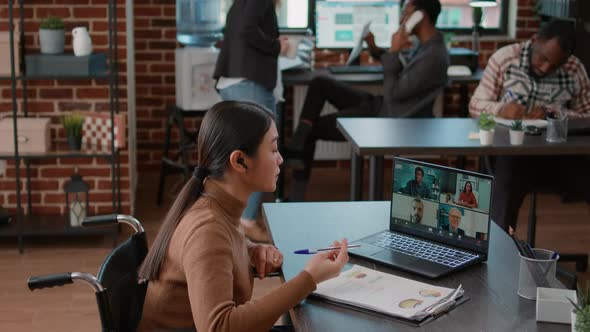 Woman Attending Videocall Meeting on Laptop with Disability Friendly Office