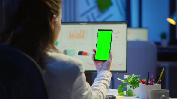 Businesswoman Looking at Green Screen Monitor of Smartphone