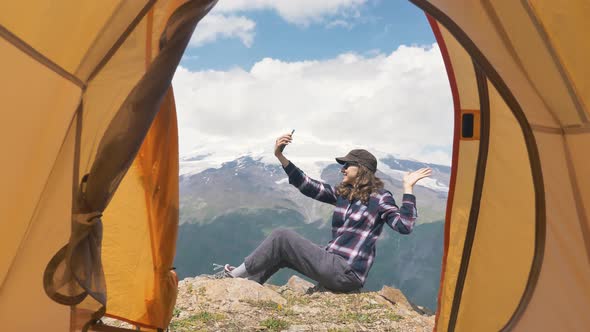 Lady Blogger Talks on Phone Showing Mountains to Subscribers