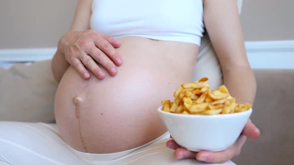 Diet During Pregnancy Concept. Pregnant Woman Eating French Fries