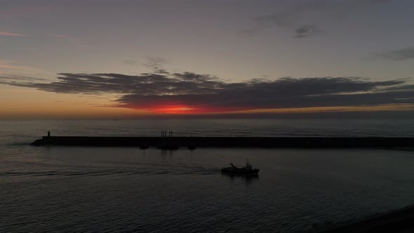 Boat Fish arriving to The Harbour at Night