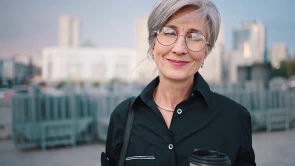 Portrait of Smiling Mature Businesswoman Standing Outdoor and Looking at Camera