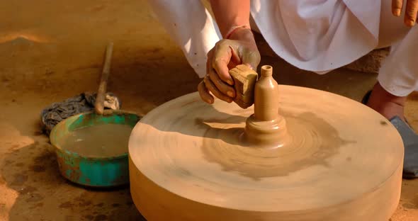 Pottery - Skilled Wet Hands of Potter Shaping the Clay on Potter Wheel. Pot, Vase Throwing