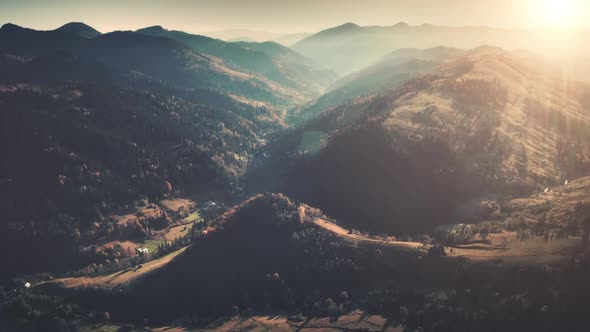 Aerial Orange Sunlight in Morning Over Mountains