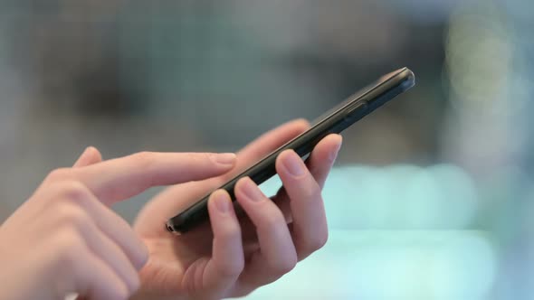 Close Up Female Hands Browsing Smartphone