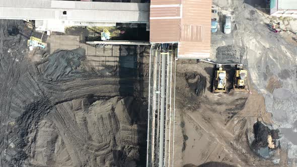 Birds Eye Aerial View of Drone Unmanned Aircraft Flying Above Mining Factory Top Down Shot