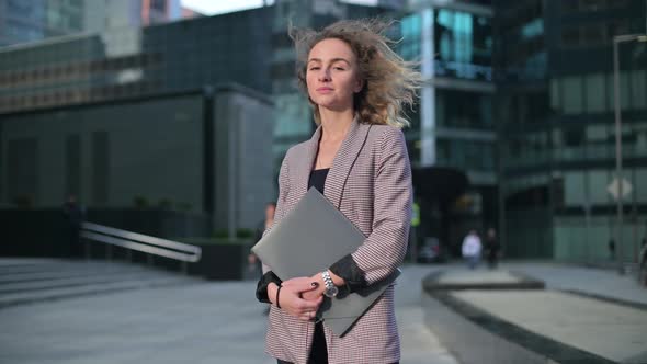 Young business woman on the background of the business center and walking people