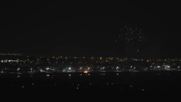 A Night Urban View with Bright Firework Over It