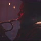 Professional trumpeter playing in a room with smoke and red neon light - VideoHive Item for Sale
