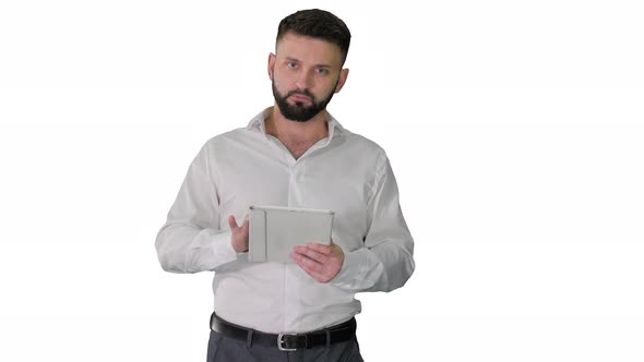 Serious Young Male Executive Using Digital Tablet and Looking To Camera Agreeing on White Background