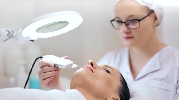 Medium Shot Professional Female Cosmetologist Wearing Medical Uniform During Working at Clinic