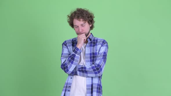 Stressed Young Bearded Hipster Man Thinking and Looking Down