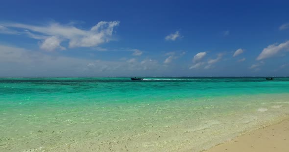 Natural aerial clean view of a sandy white paradise beach and blue ocean background in vibrant 4K