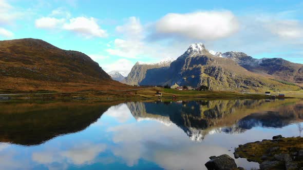 Drone flys over a lake towards a mountain. Beautiful landscape in norway