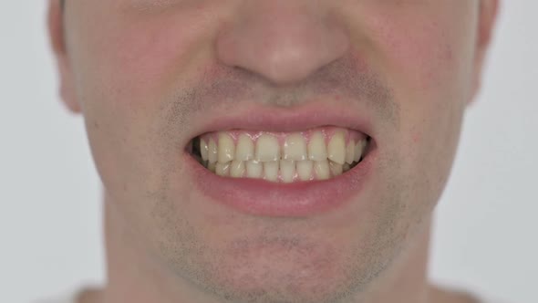 Close Up of Angry Young Man Crunching Teeth