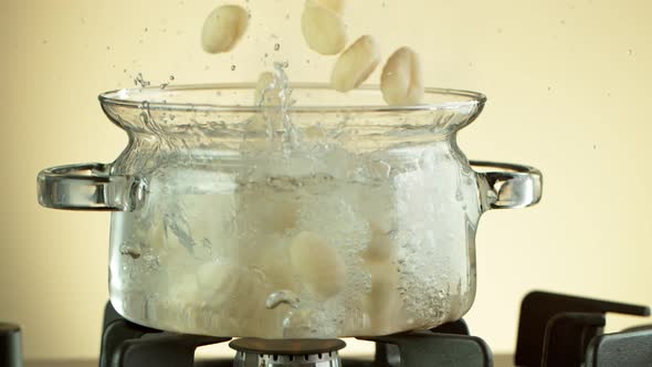 Super Slow Motion Shot of Fresh Gnocchi Falling Into Boiling Salted Water at 1000 Fps.