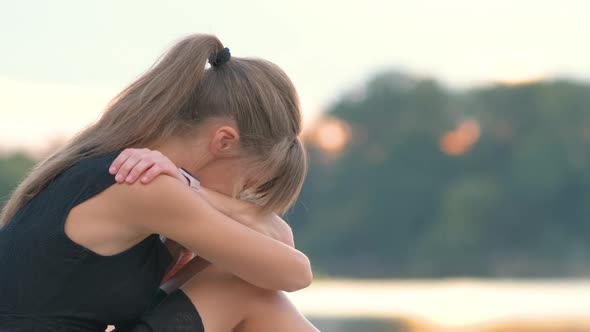 Sad Young Woman Sitting Alone Outdoors Crying Bitterly