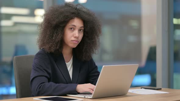 African Businesswoman with Laptop Saying No By Finger Sign
