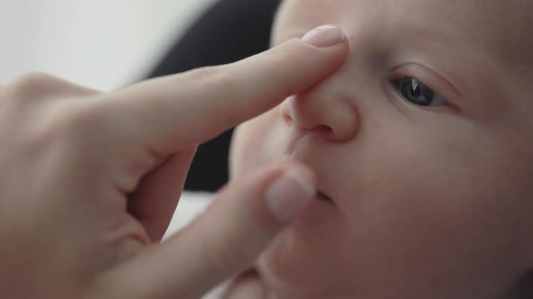 Close Up of Female Hands Touching Cute Newborn Baby